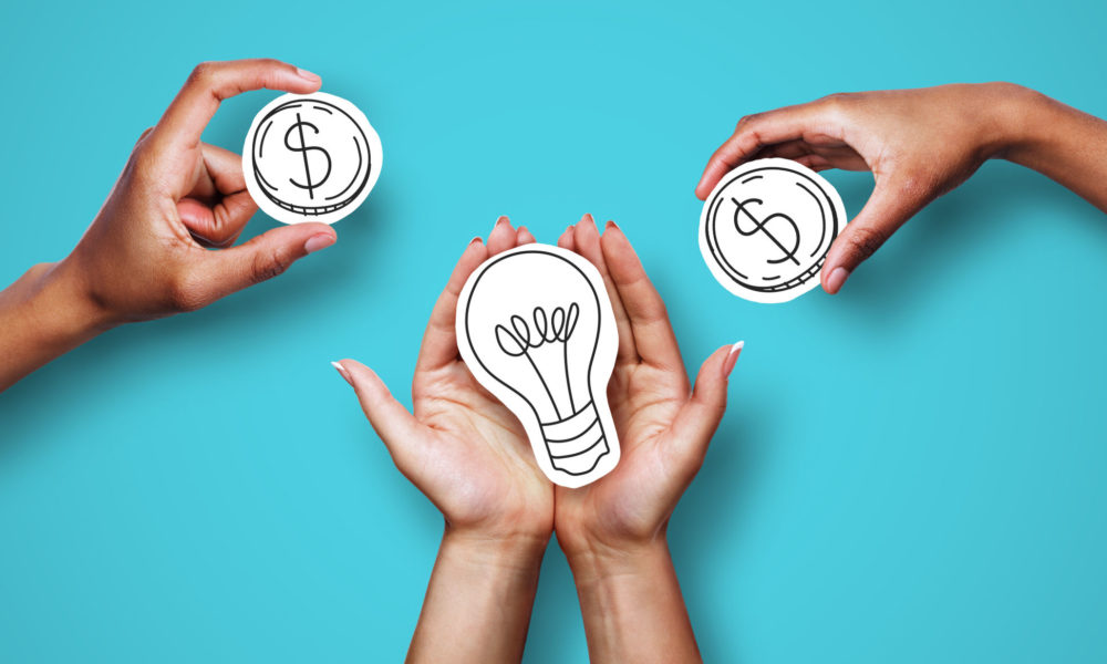 Money for startup, startup financing. Hands with dollar sign coins and light bulb over blue background, creator asking investors for money